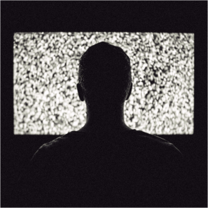 A man watching TV on a close range | common health myths