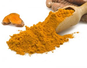 Curcumin powder in wooden spoon
